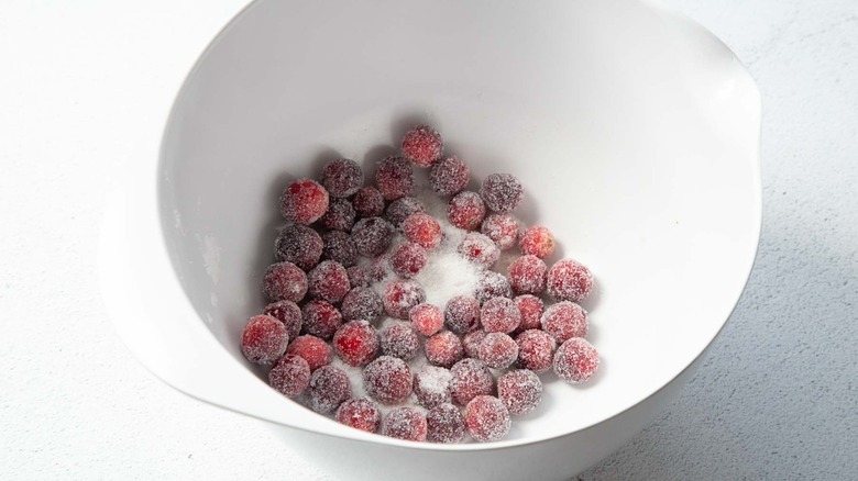 Cranberries in a bowl of sugar