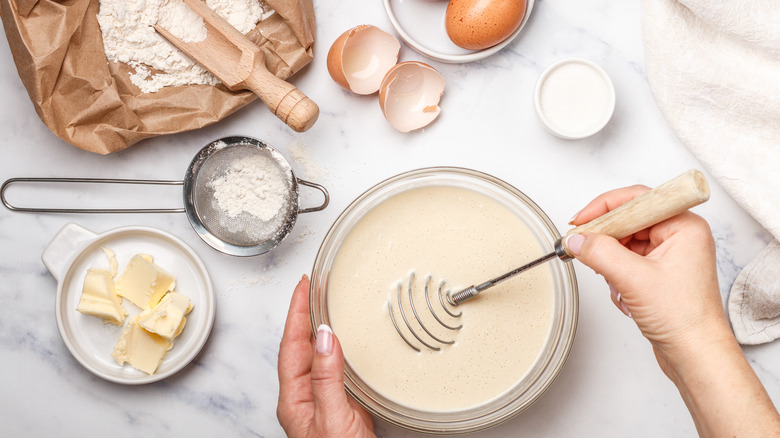 Hands mixing pancake batter