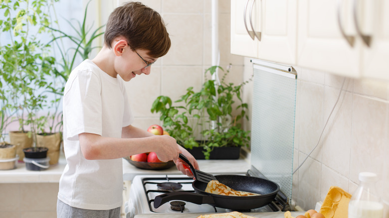 Young person making pancakes