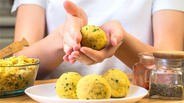 Hands forming falafel mixture