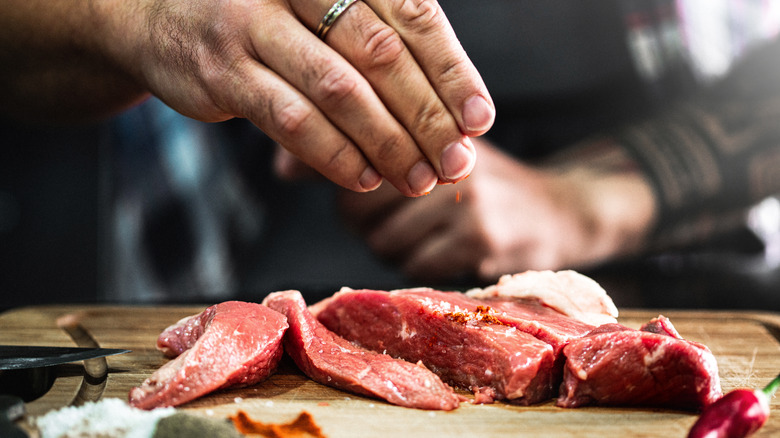 raw beef slices on cutting board 