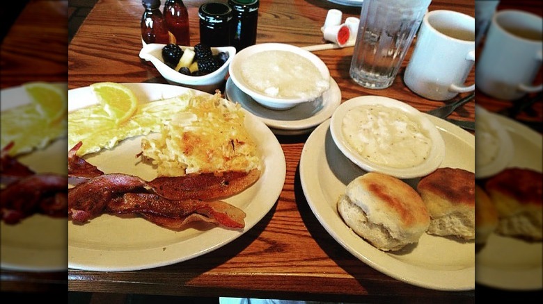 Breakfast with grits, eggs, bacon, biscuits, gravy