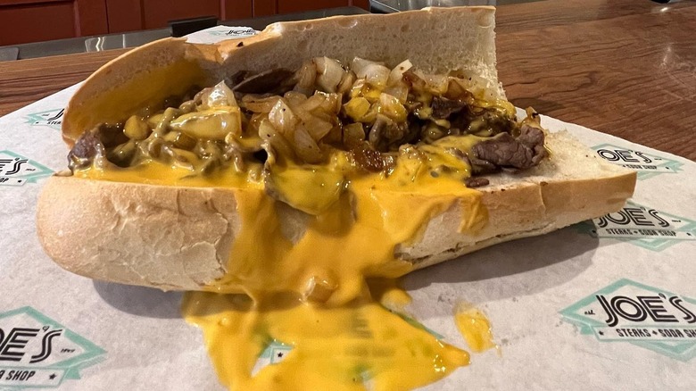 Cheese smothered cheesesteak on paper