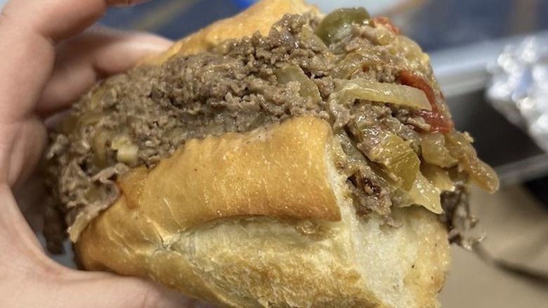 hand holding a Rocco's Cheesesteak
