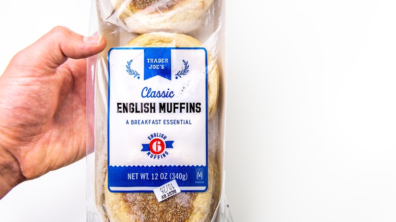 Hand holding packaged English muffins