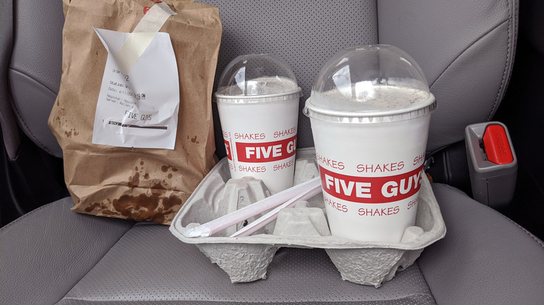 Five Guys milkshakes in a car seat