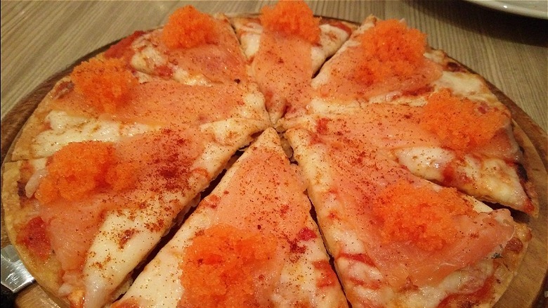 Pizza topped with salmon and roe