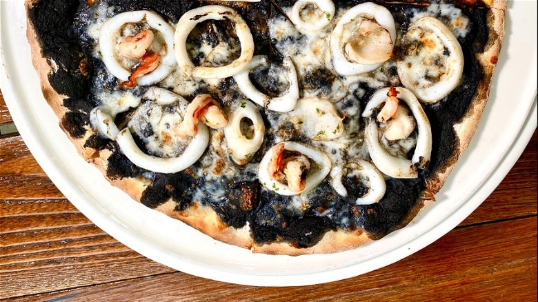 Pizza with squid ink sauce
