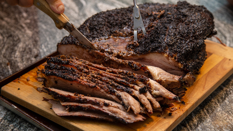 Smoked beef brisket being cut