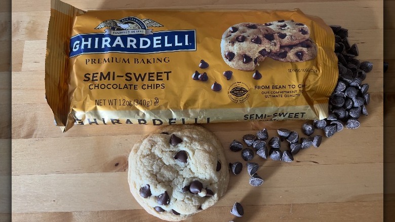 Ghirardelli chocolate chips on wooden counter