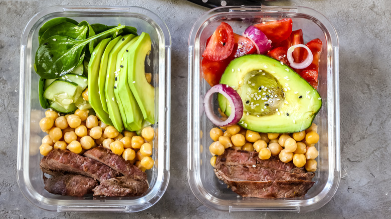 Containers with meat, avocado, and vegetables 
