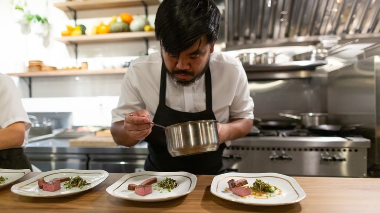 Chef of Archipelago Seattle serving food