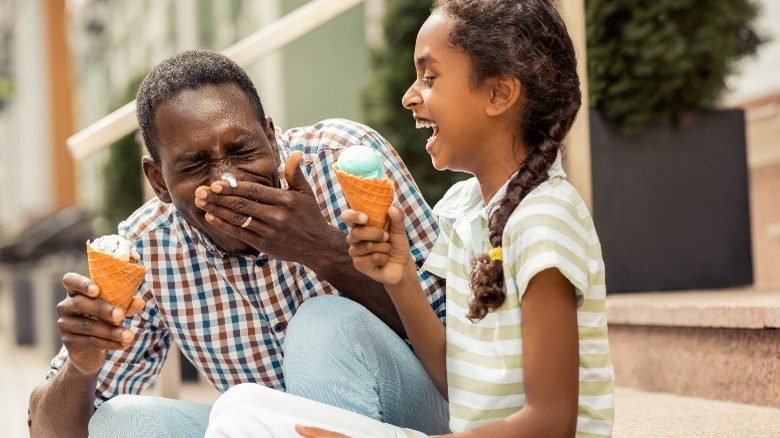 Dad and daughter eating ice cream cones