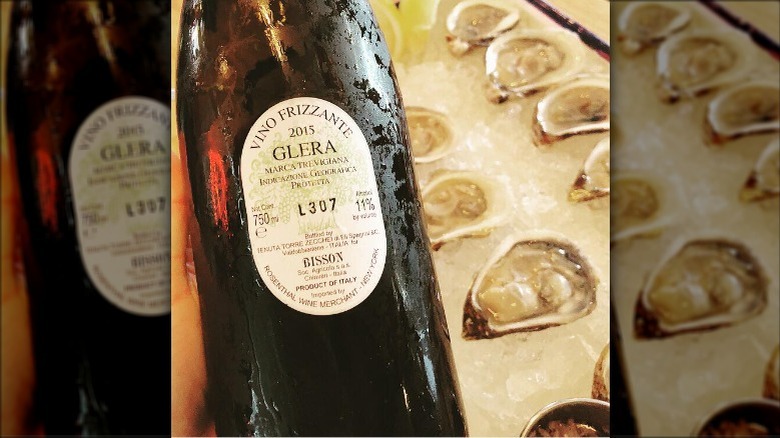 bottle of bisson glera frizzante over tray of oysters