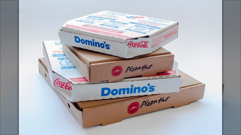 Stacked Domino's and Pizza Hut boxes