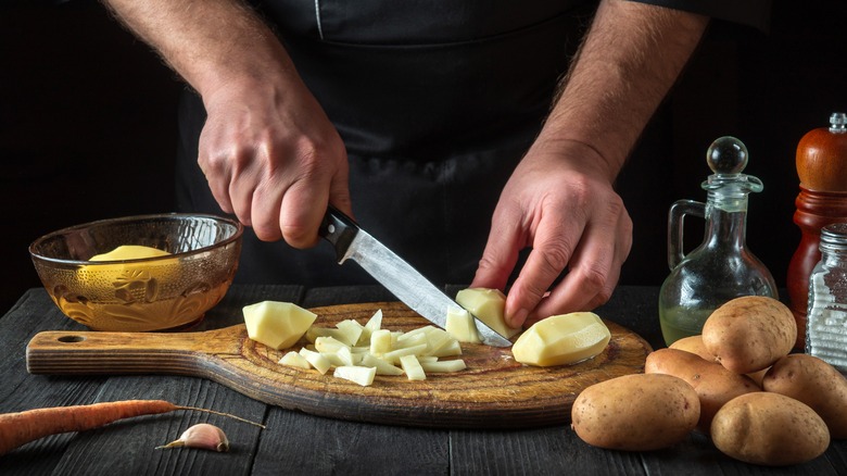 Person cutting potatoes