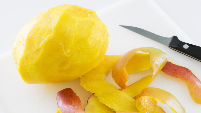 peeled mango and paring knife