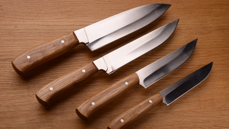 four knives with wood handles