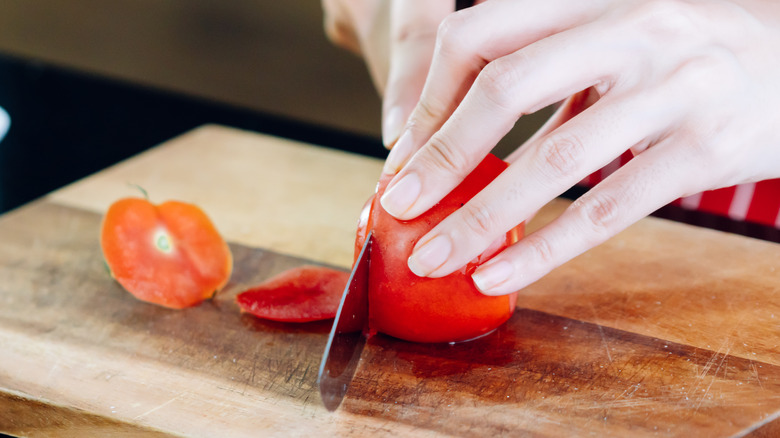 cutting tomato with knife