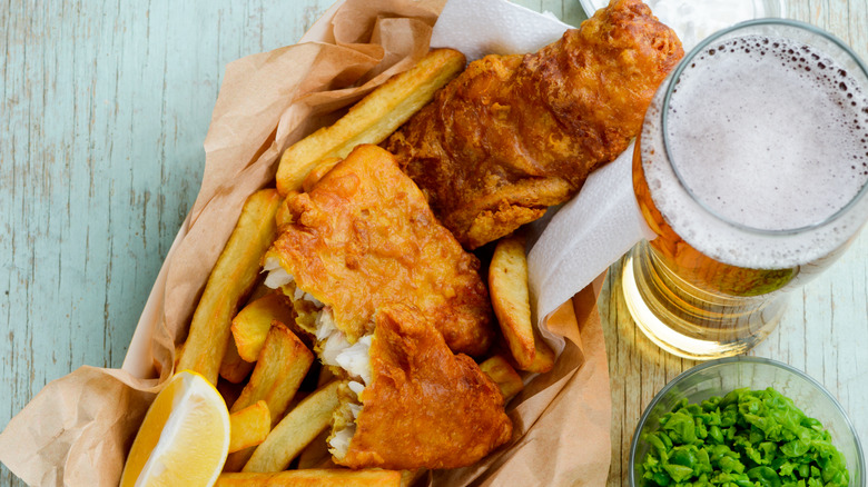 fish and chips with glass of light beer