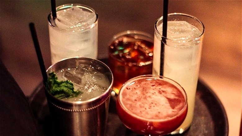 four Sampan happy hour drinks on tray