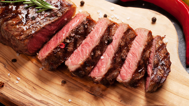 Strip steak on cutting board