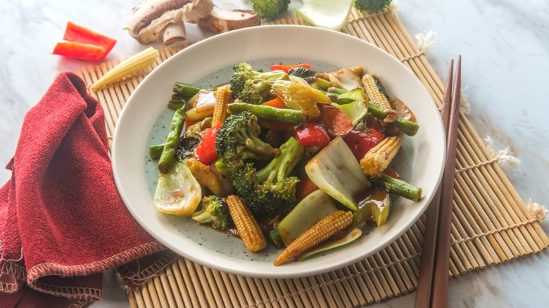 plate of sauteed mixed veggies by red napkin