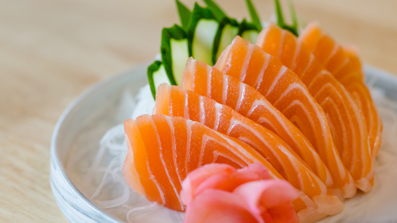 salmon, ginger, and cucumber on white plate