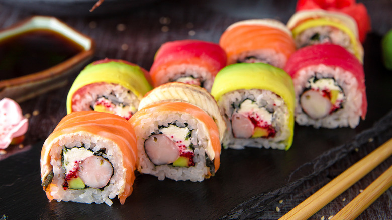 colorful sushi pieces on black plate