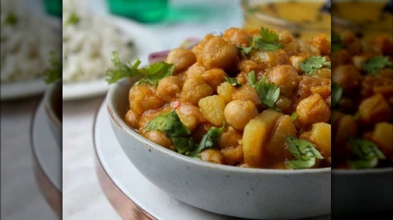 chickpea and potato curry in bowl with cilantro