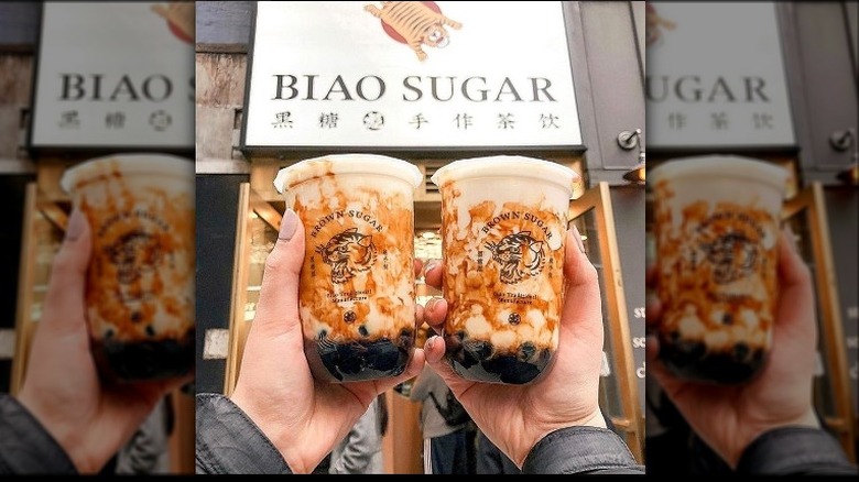 Hands holding Biao Sugar drinks