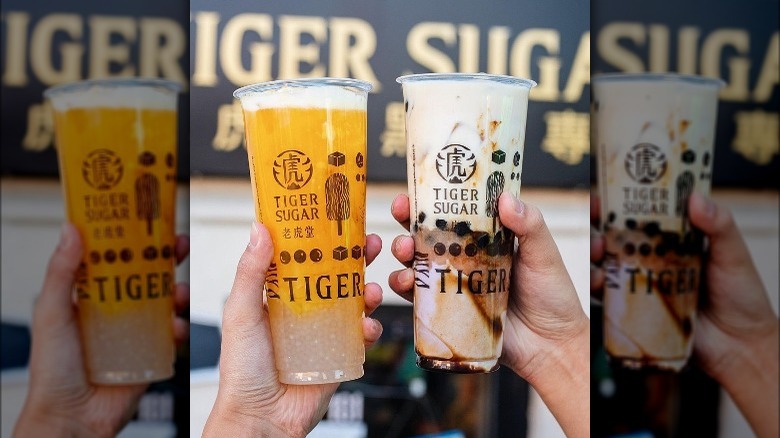 Hands holding Tiger Sugar drinks