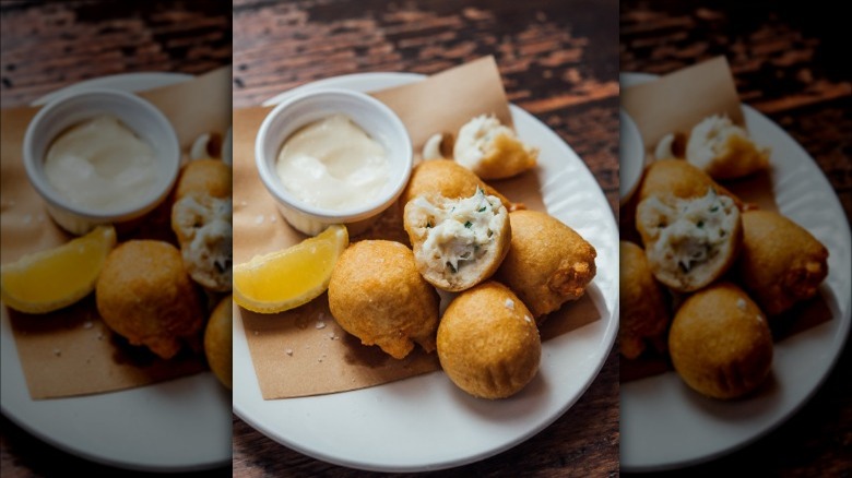 Crab beignets on a white plate