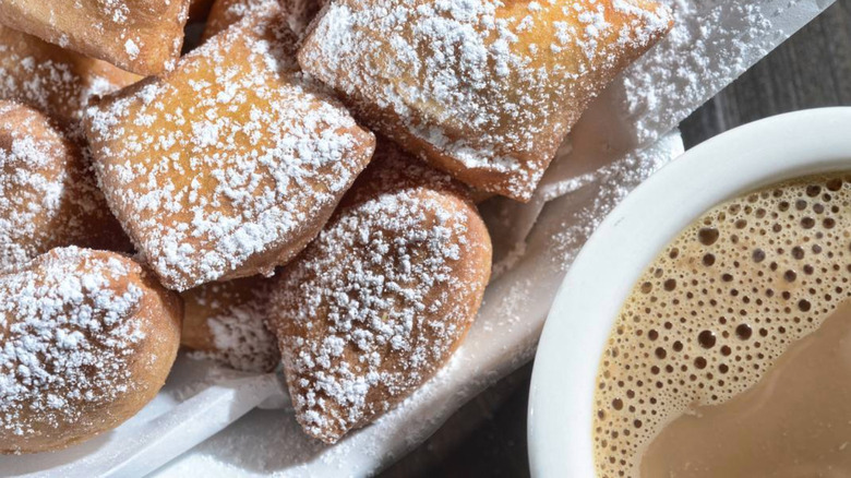 closeup of beignets and coffee