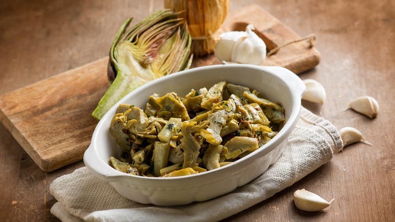 casserole dish with cut artichoke