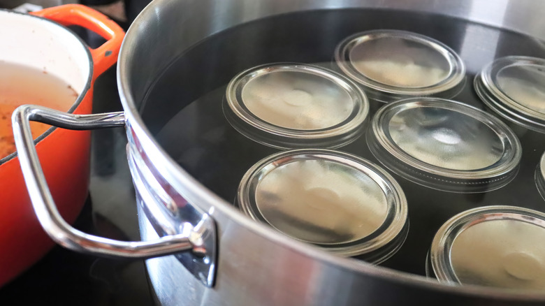 pickling jars in pot of water