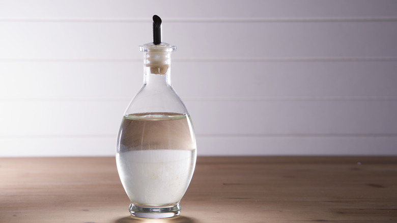 white vinegar on wooden table