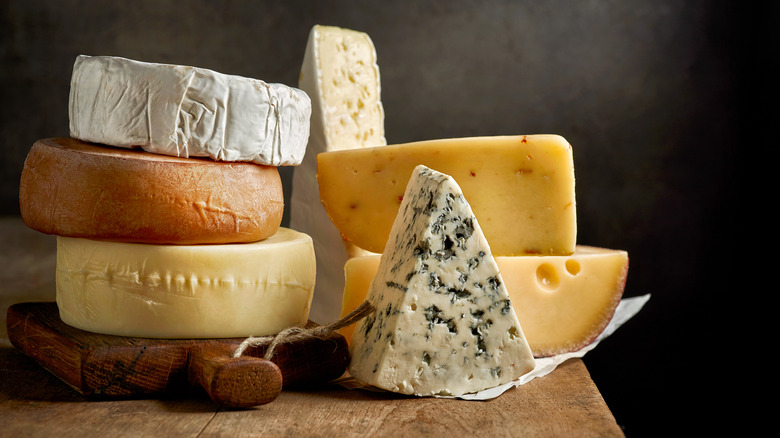 cheeses on a wooden board