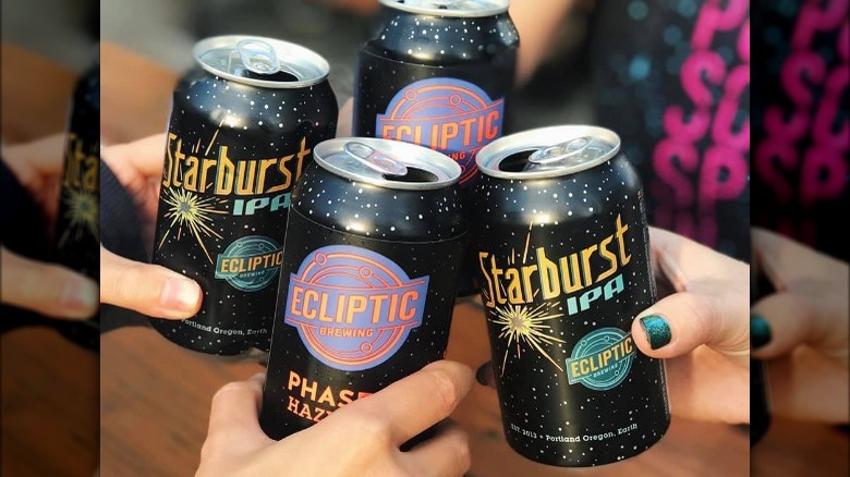 Hands cheering with Ecliptic's beer