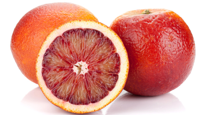 Whole and cut blood oranges