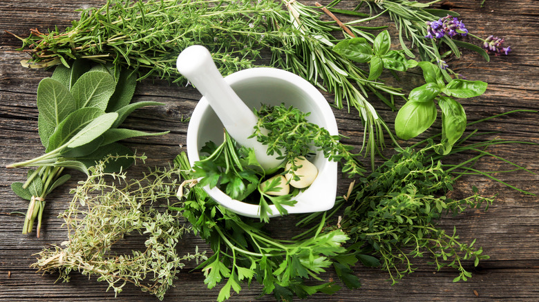 Fresh herbs and mortar pestle