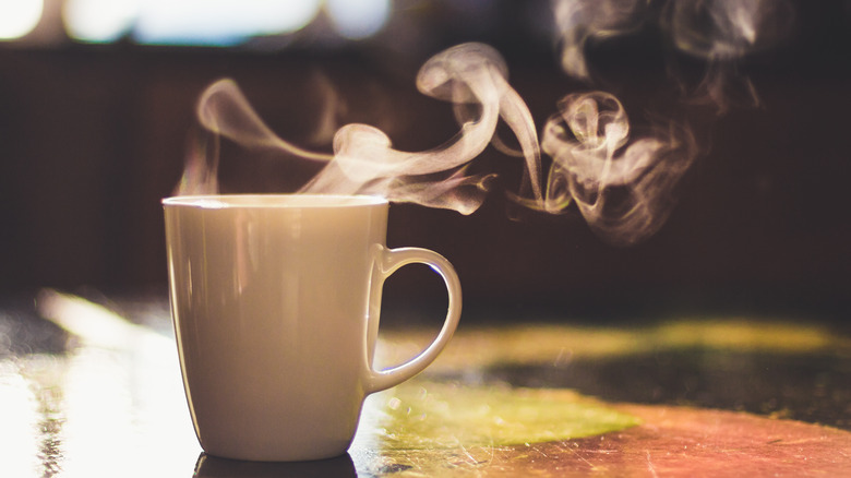 Steaming mug on table