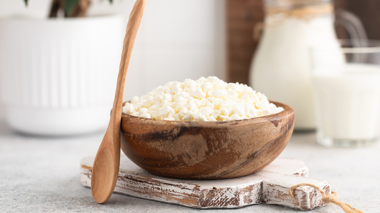 A wooden bowl of cottage cheese