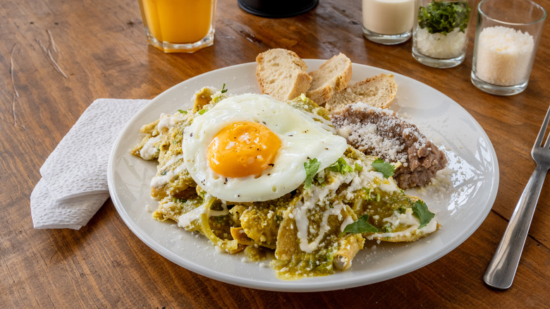 Chilaquiles with refried beans and egg