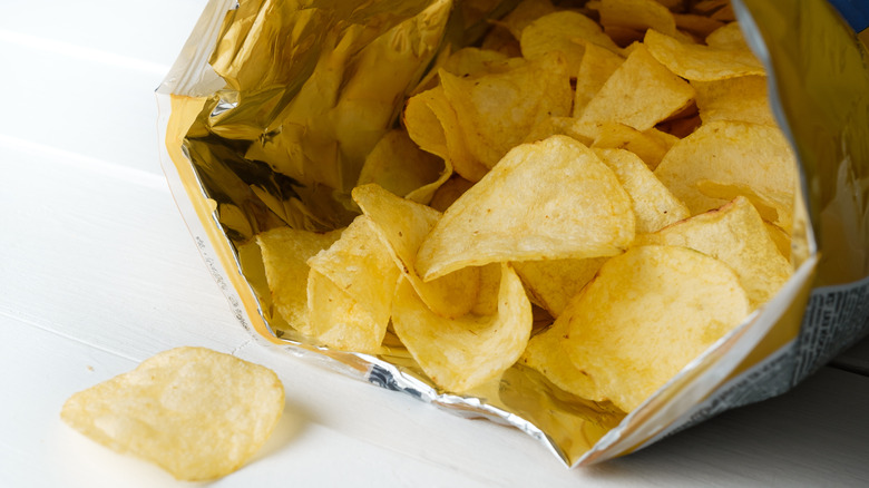 bag of Lay's potao chips open with chips spilling out