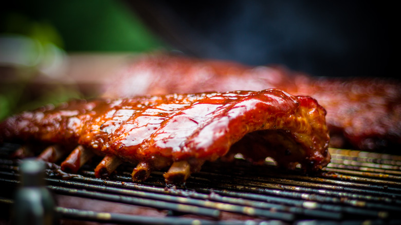 Ribs on grill with sauce