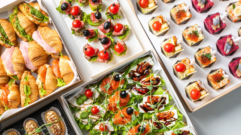 Various appetizers on little white plates