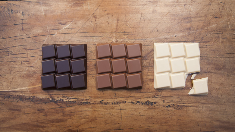 Three types of chocolate on wood surface