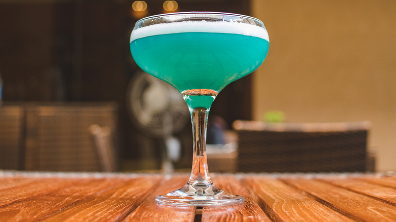 blue cocktail in coupe glass