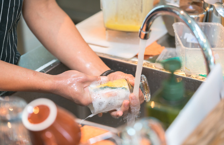 Wash dishes by hand